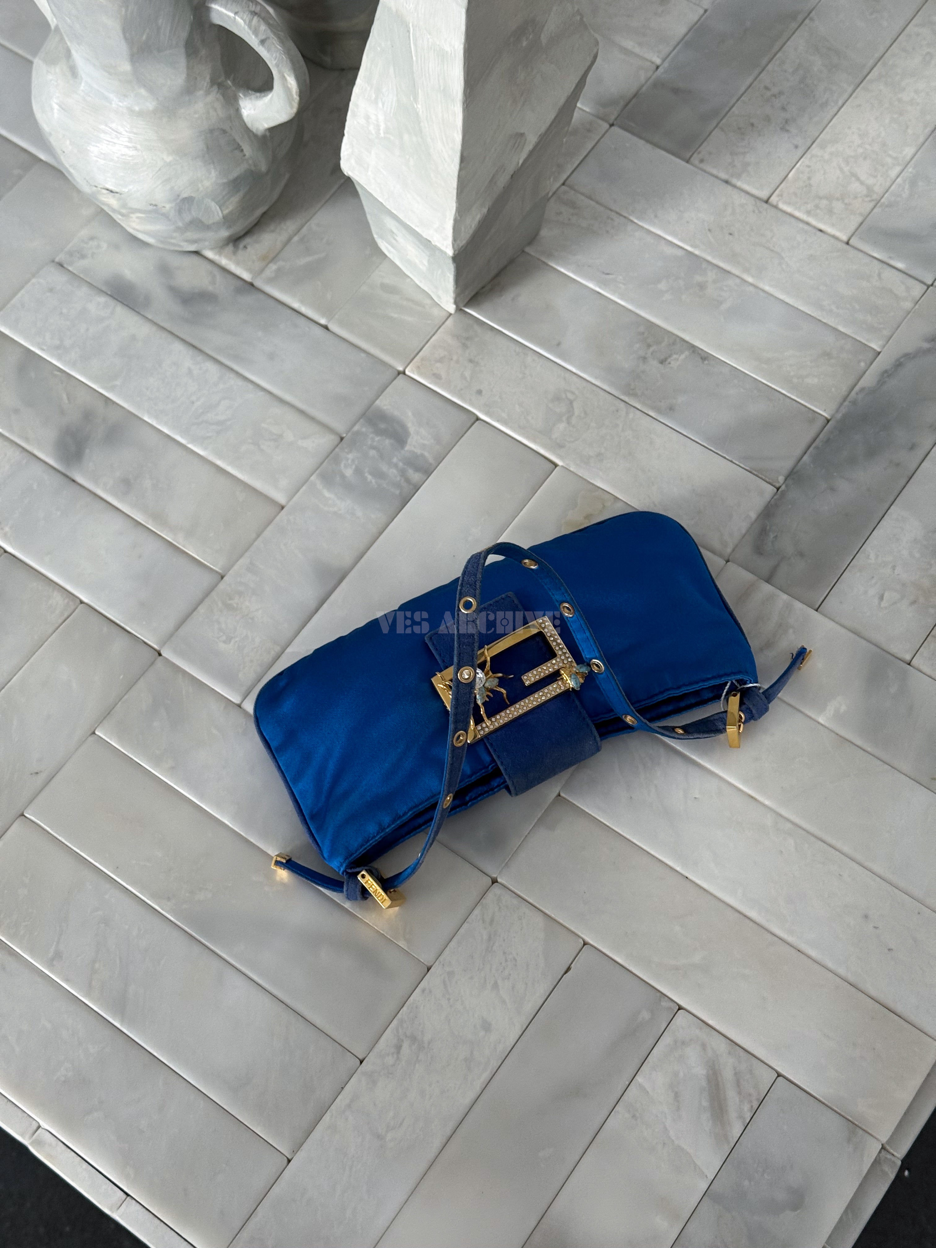 Fendi blue satin Baguette shoulder bag featuring a spider crystal clasp.